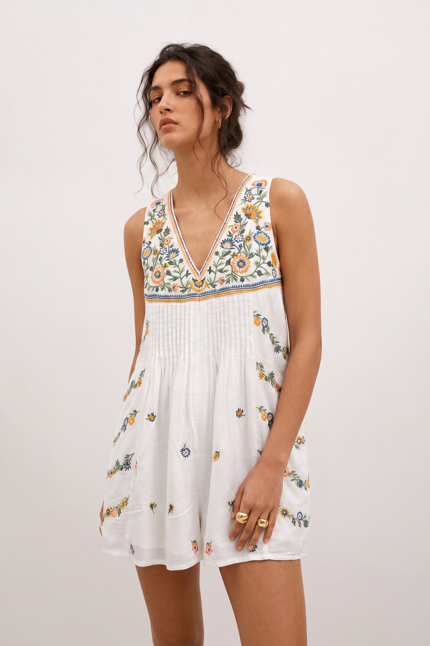 Short white romper for ladies with floral embroidery.