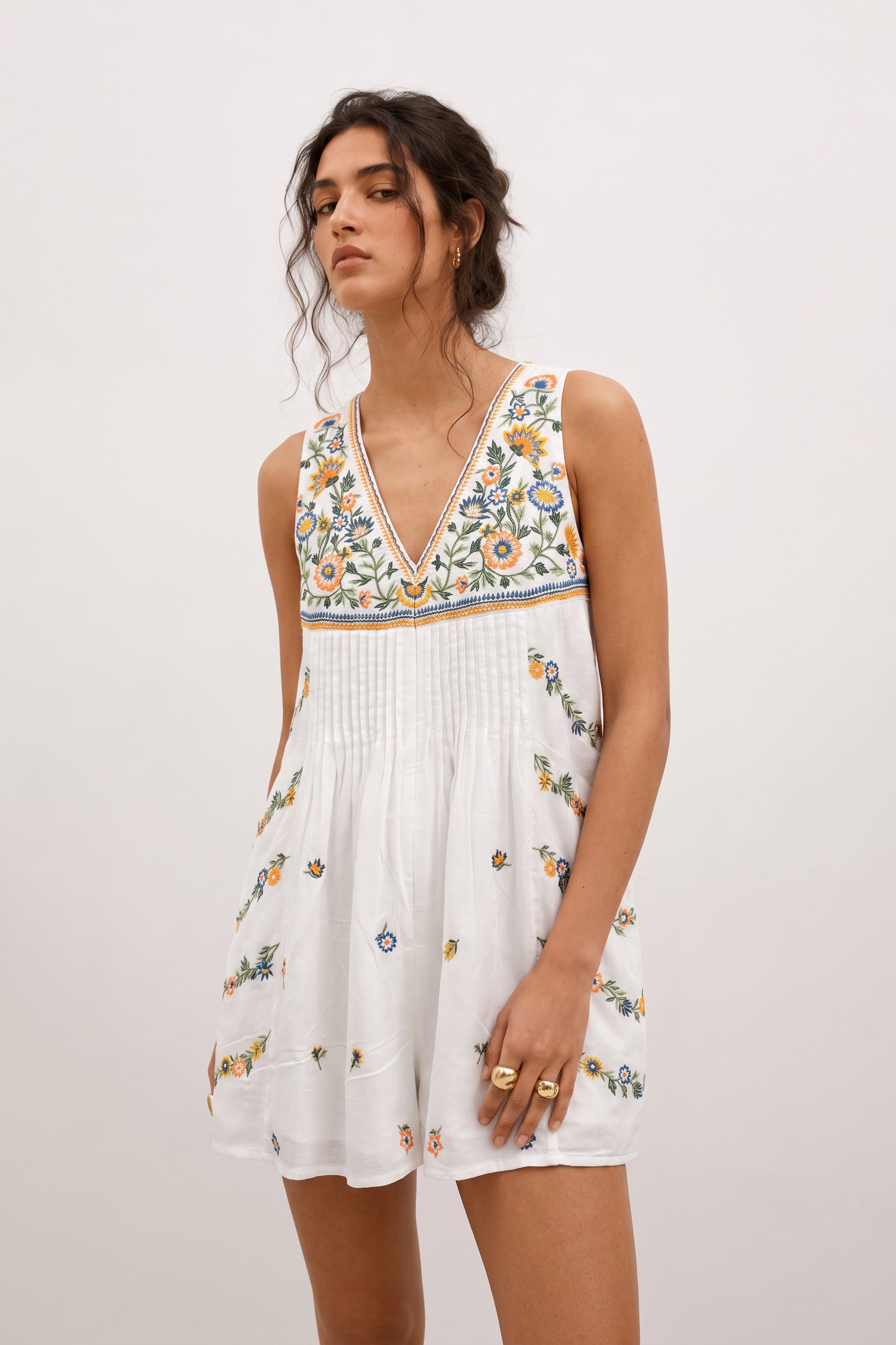 Short white romper for ladies with floral embroidery.