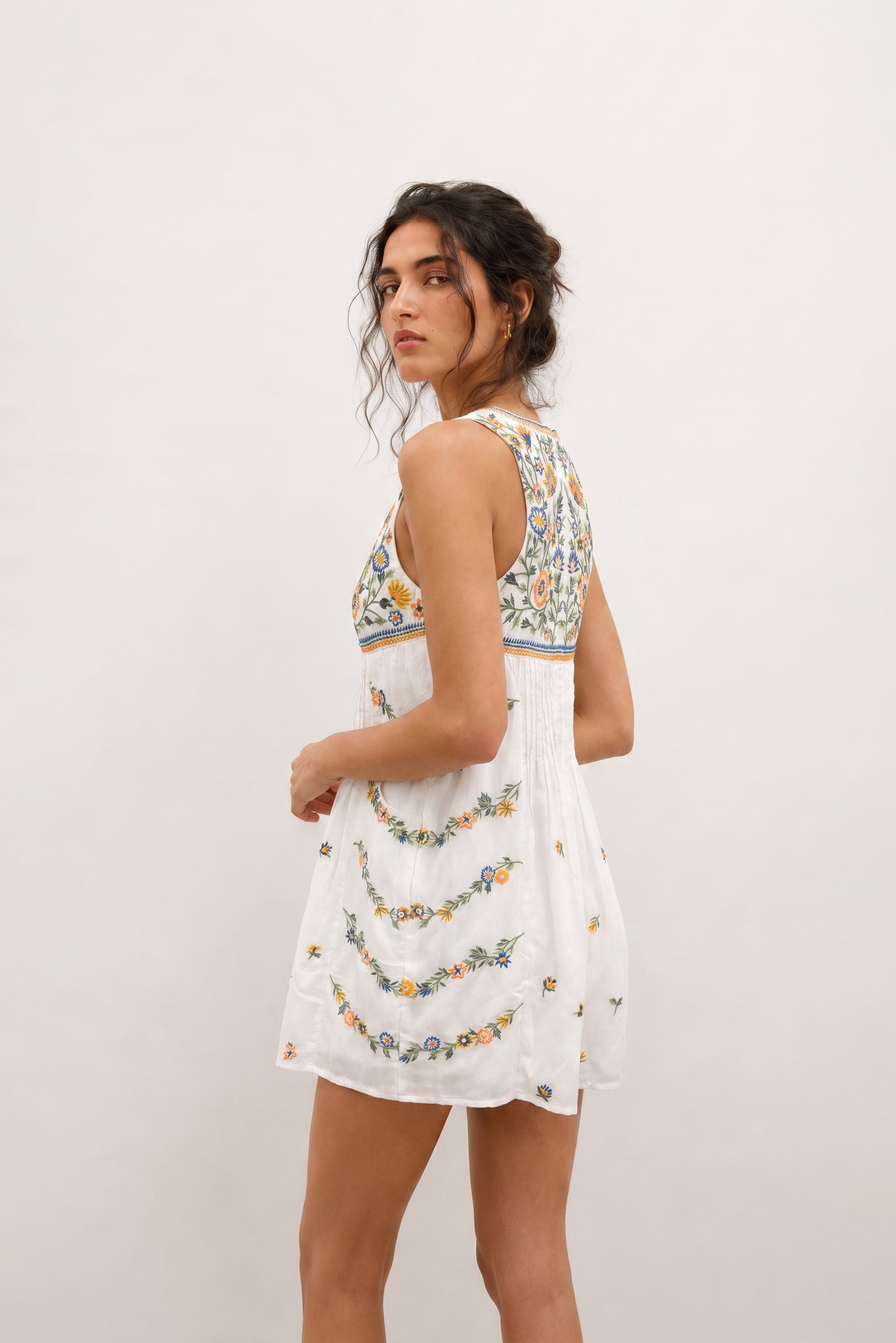 Short white romper for ladies with floral embroidery.