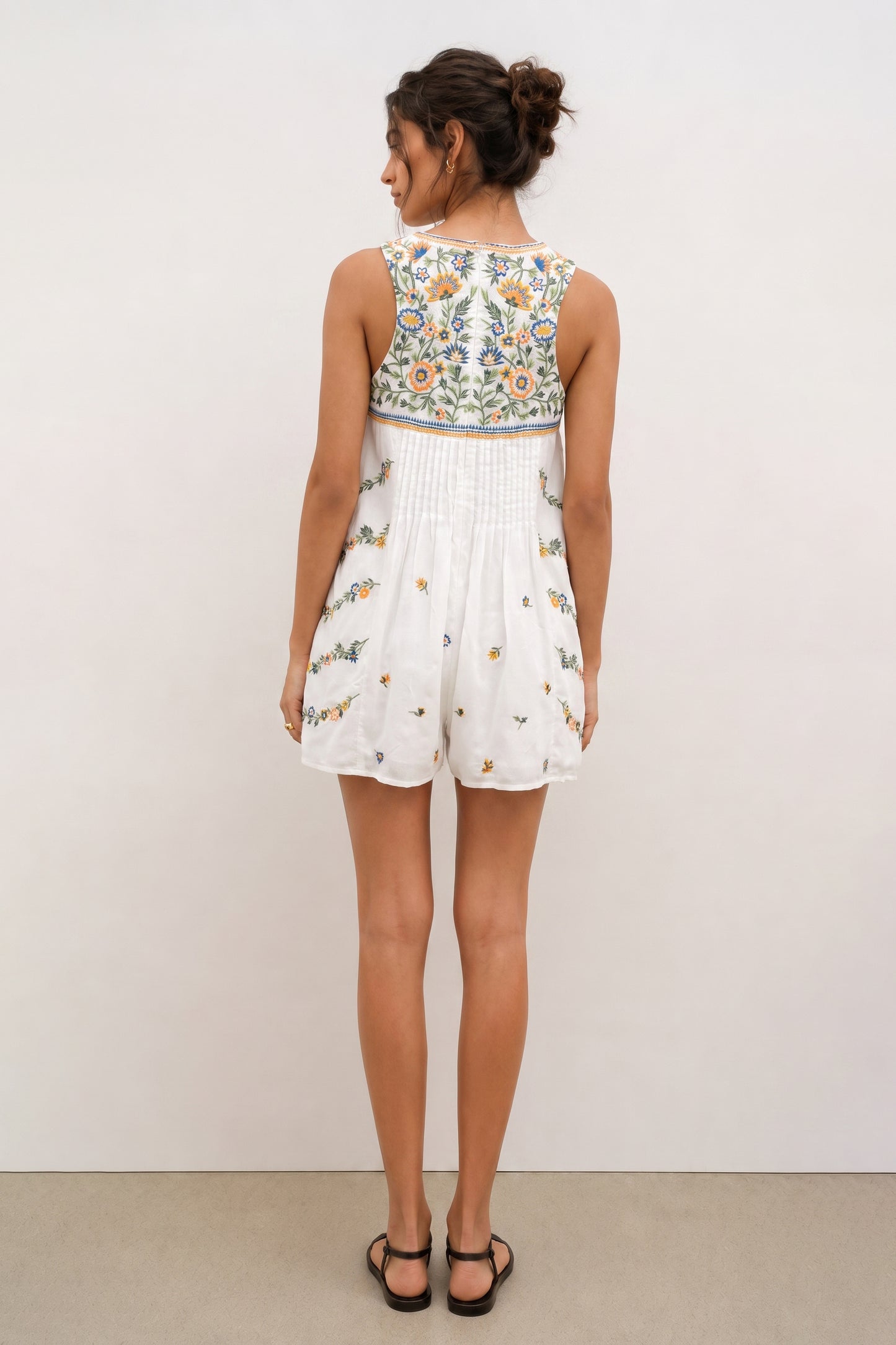 Short white romper for ladies with floral embroidery.