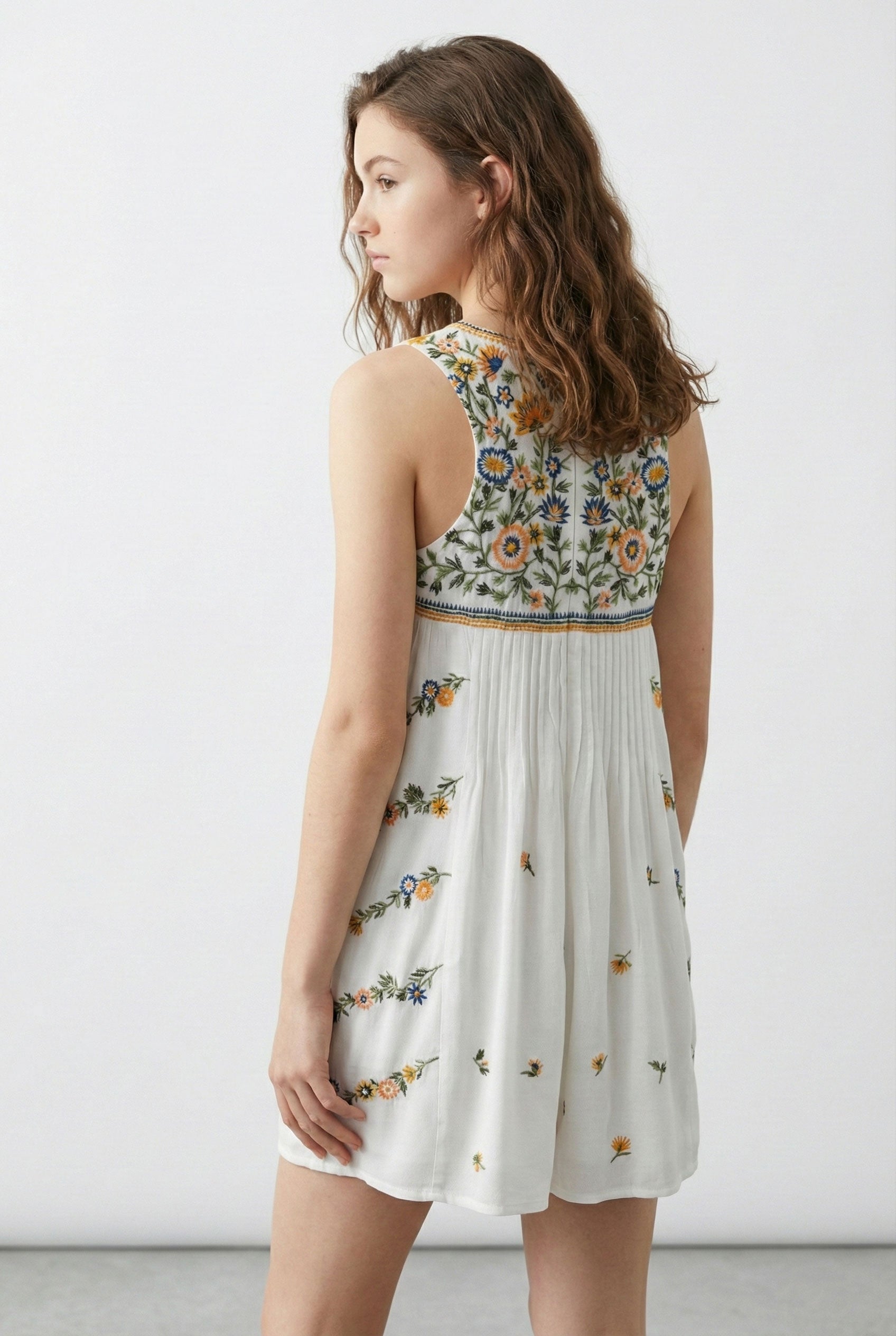 Woman wearing a floral dress with a white background