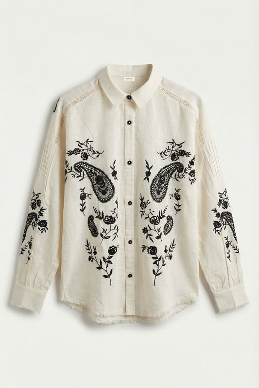White shirt with black floral and paisley embroidery on a white background