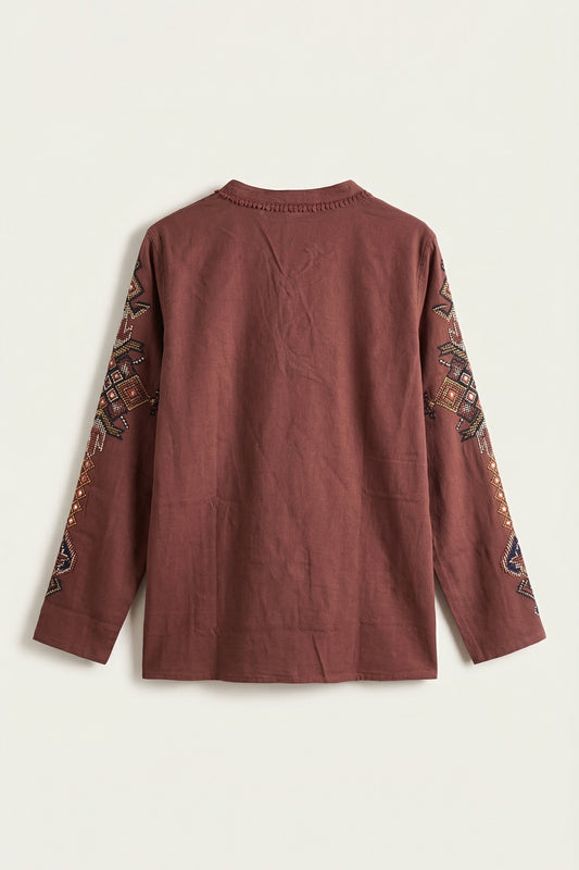 Brown long-sleeve top with intricate patterns on sleeves against a white background