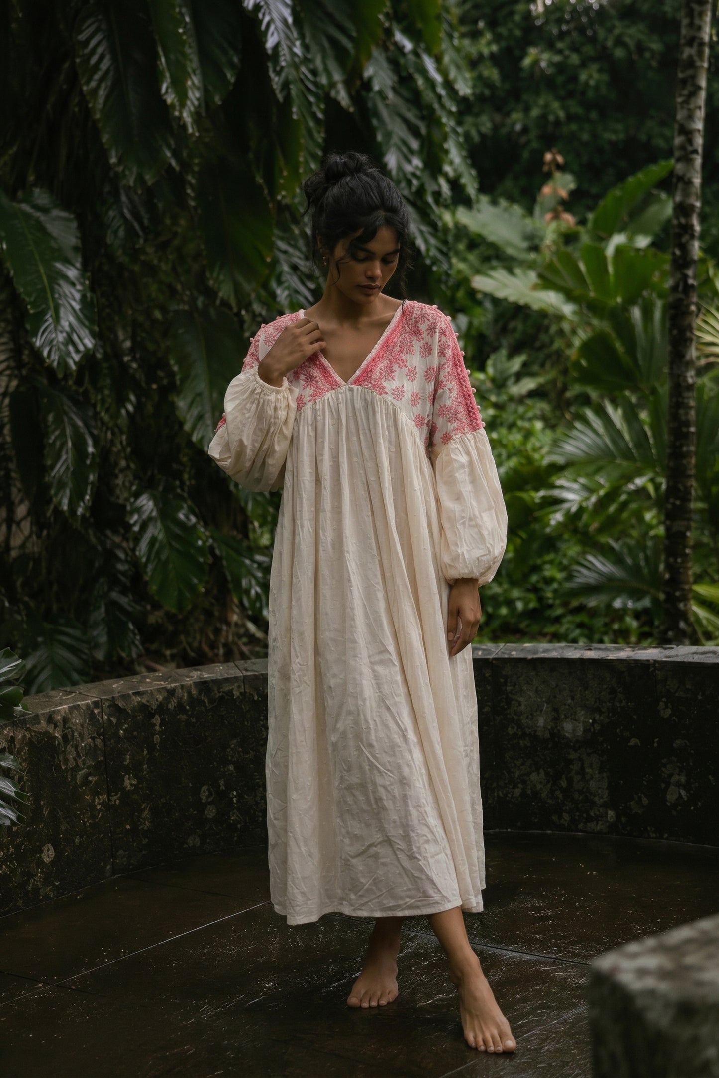 Woman in a floral dress standing in a tropical setting