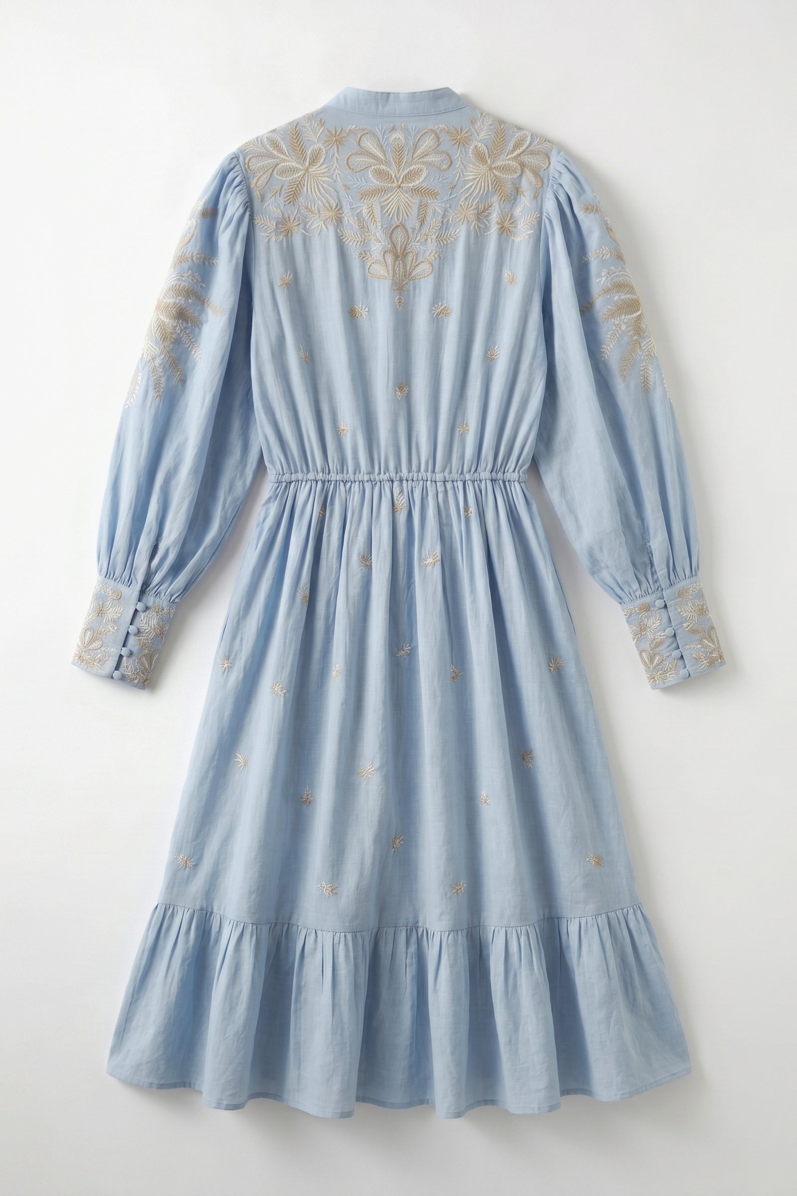 Light blue dress with intricate gold embroidery on a white background