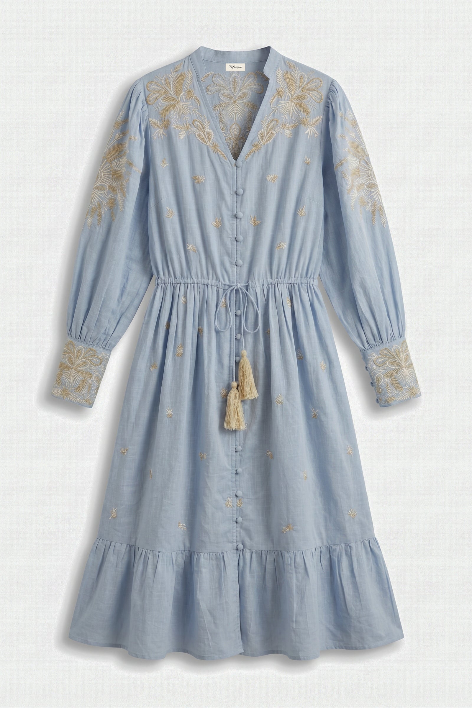 Blue dress with floral embroidery on a white background
