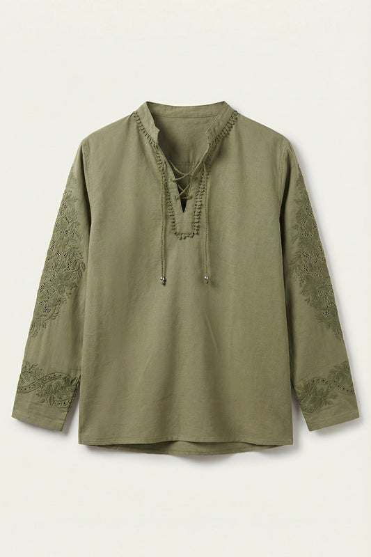 Green long-sleeve top with lace details on a white background