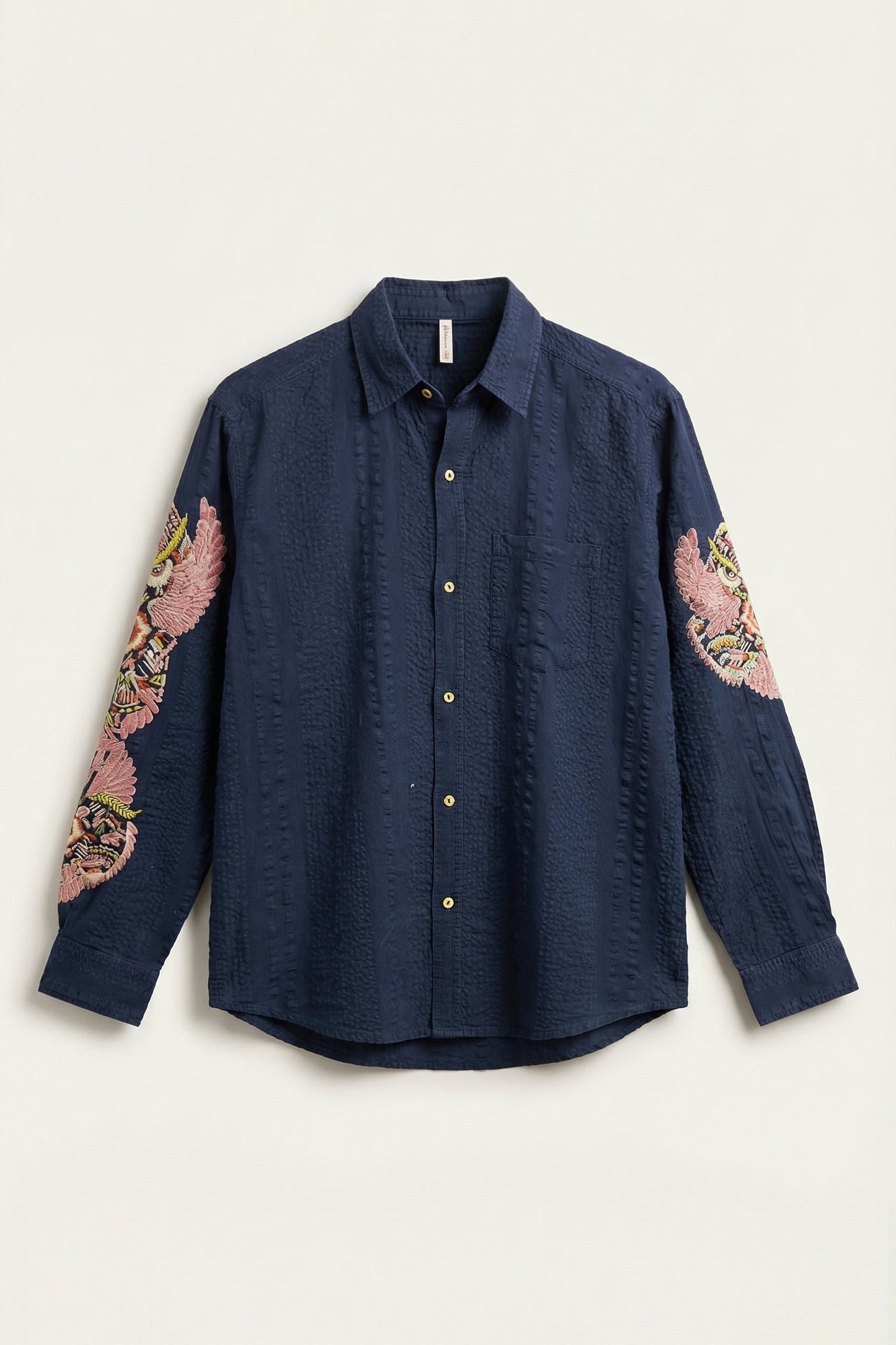 Navy shirt with floral sleeve designs on a white background