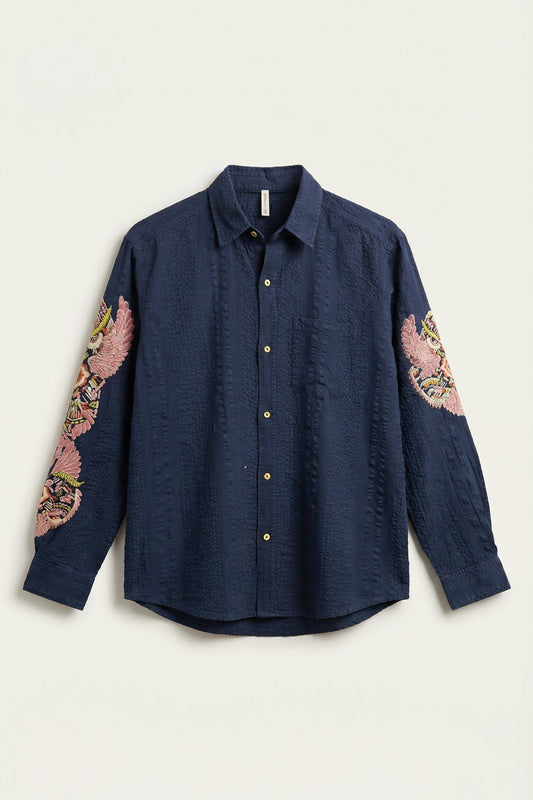 Navy shirt with floral sleeve designs on a white background
