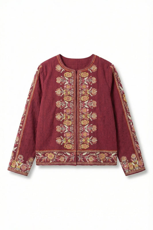 Red embroidered blouse on a white background