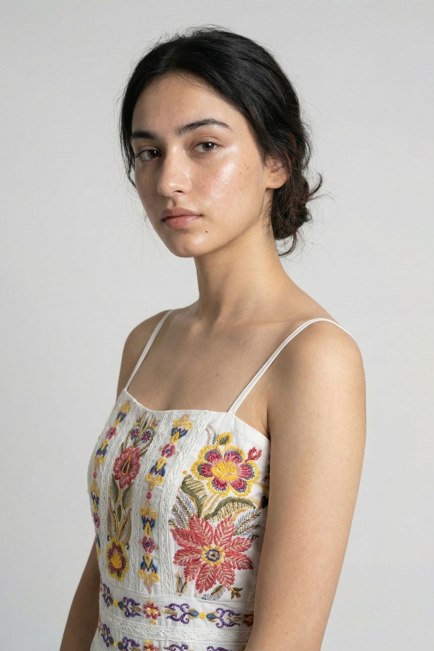 Woman wearing a floral dress against a plain background