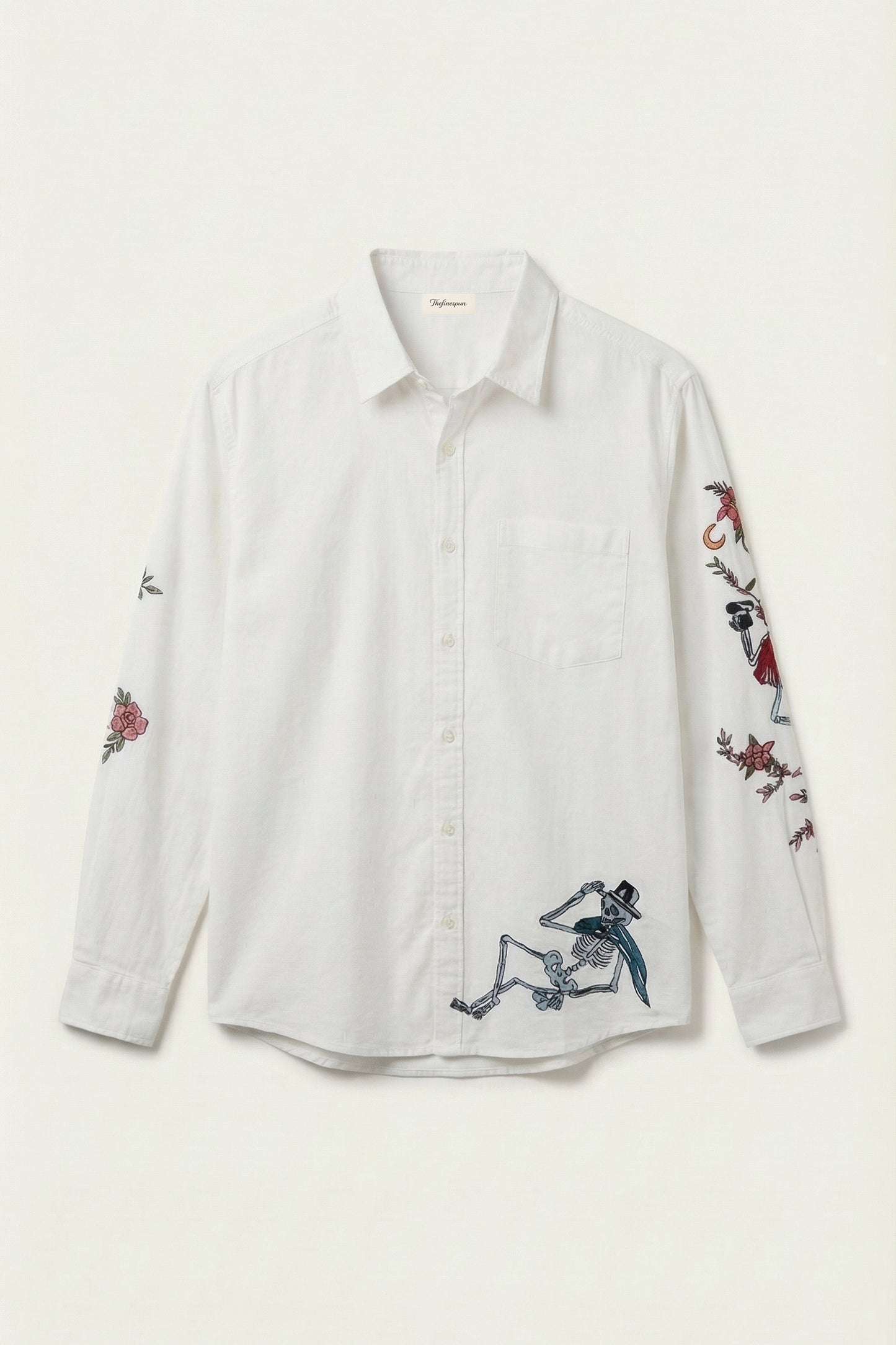 White shirt with embroidered designs on a white background