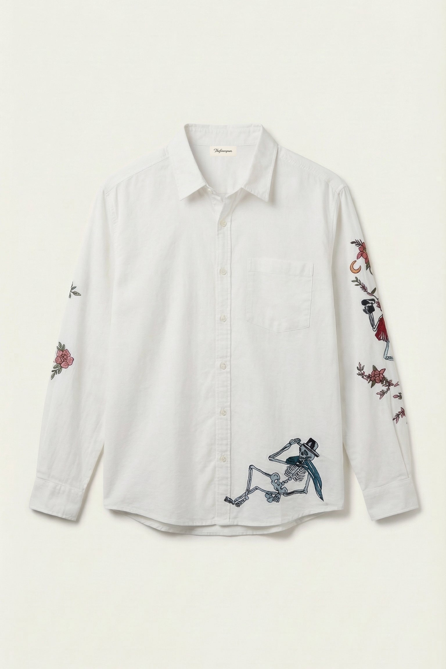 White shirt with embroidered designs on a white background