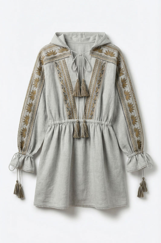 Light gray dress with intricate embroidery and tassel details on a white background