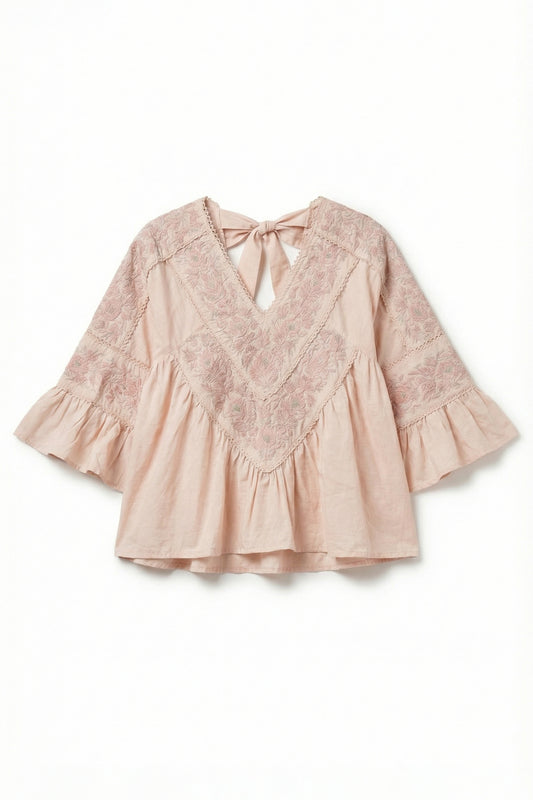Pink lace blouse with ruffled sleeves on a white background