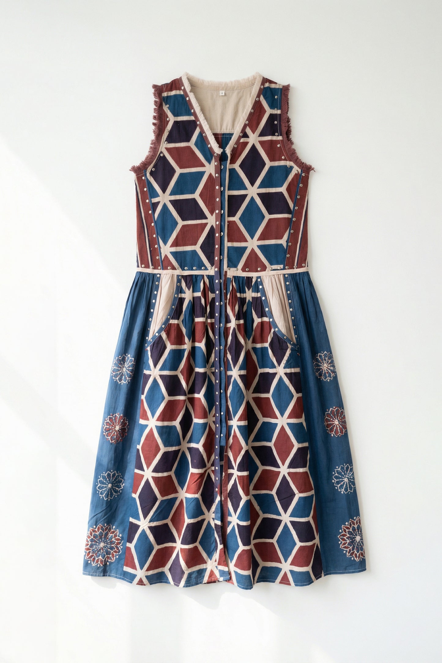 Multicolored geometric patterned dress on a white background