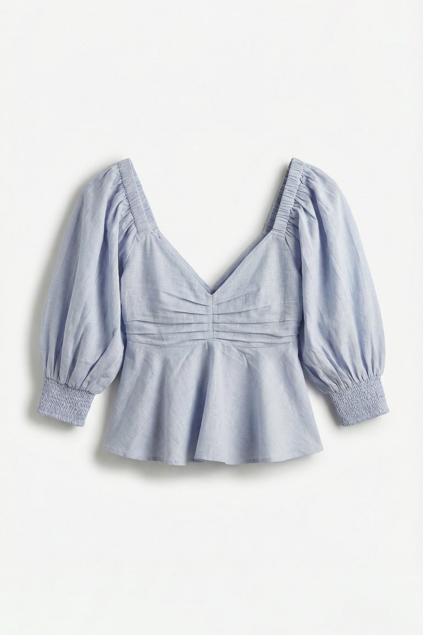 Light blue blouse with puff sleeves on a white background