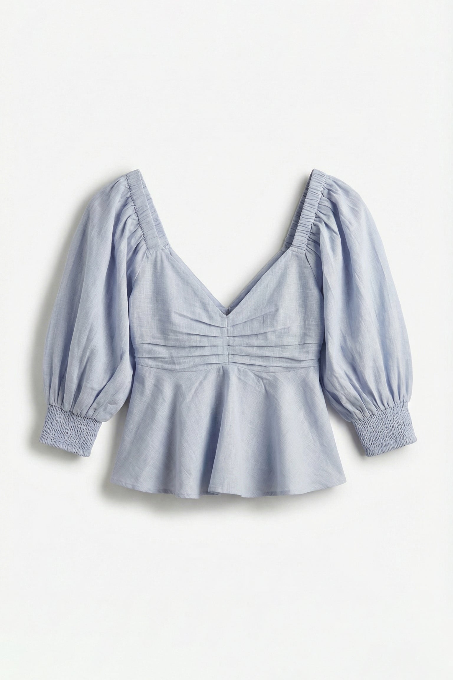 Light blue blouse with puff sleeves on a white background