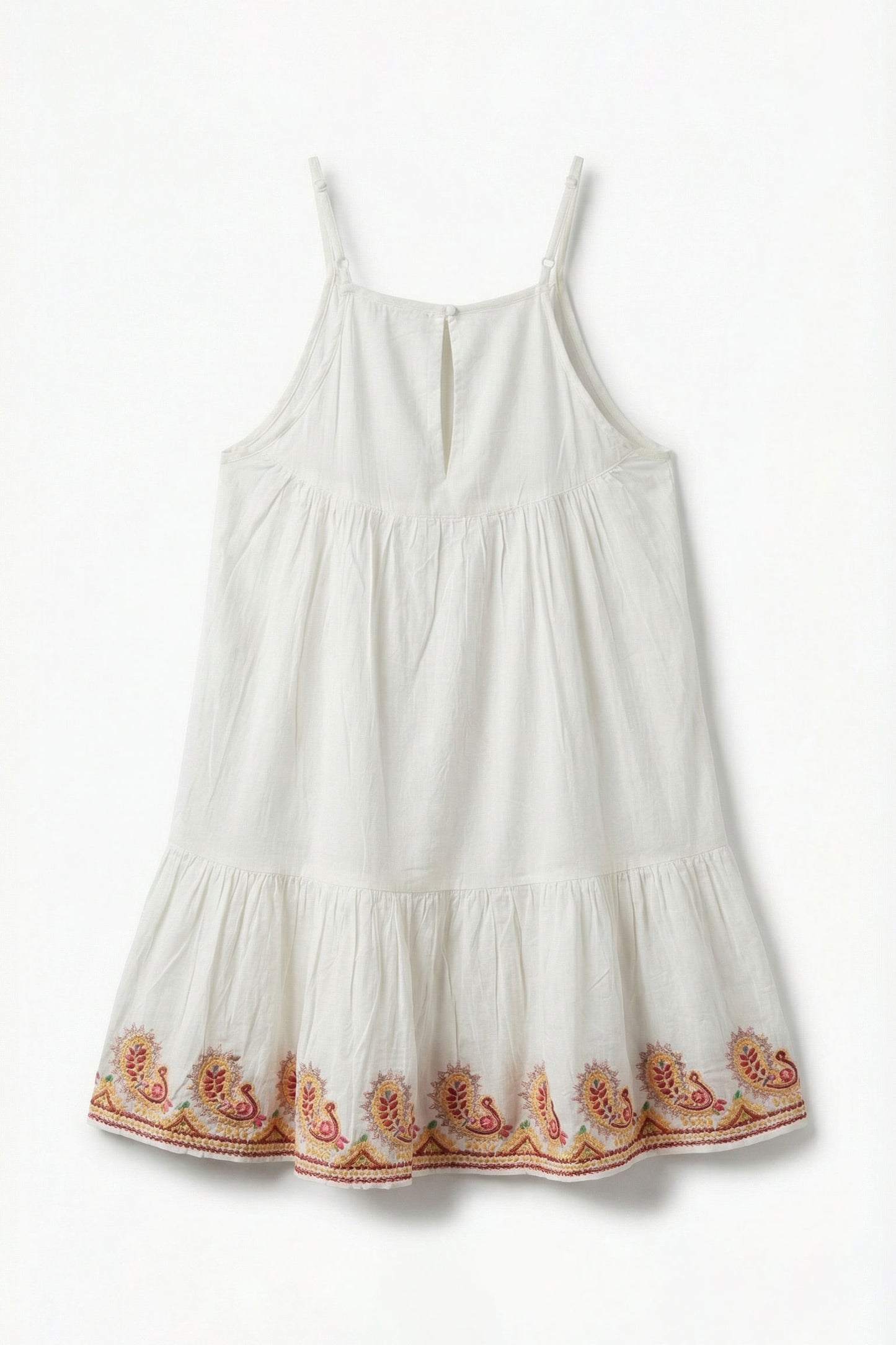 White dress with floral embroidery on a white background
