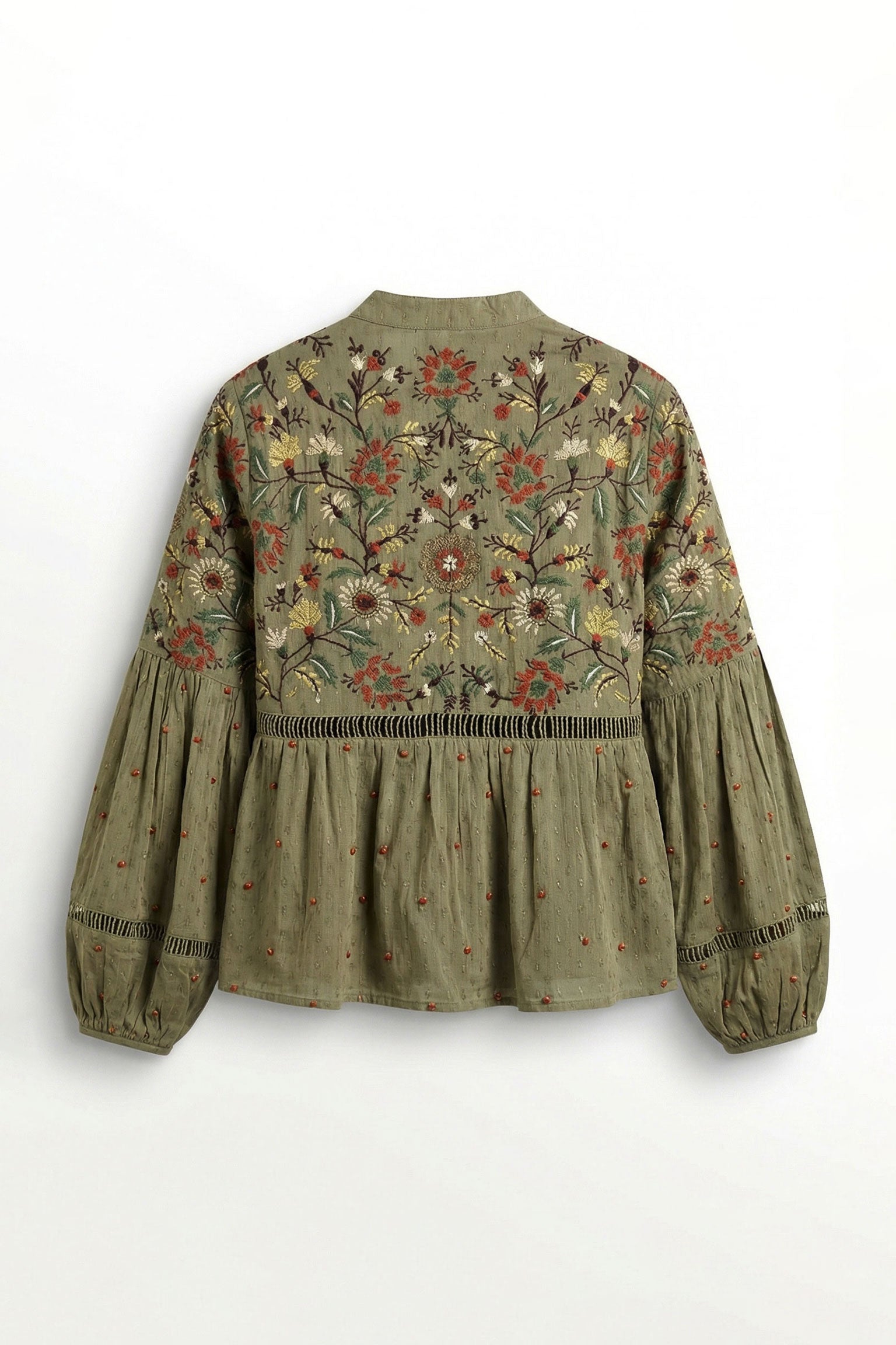 Green embroidered blouse on a white background