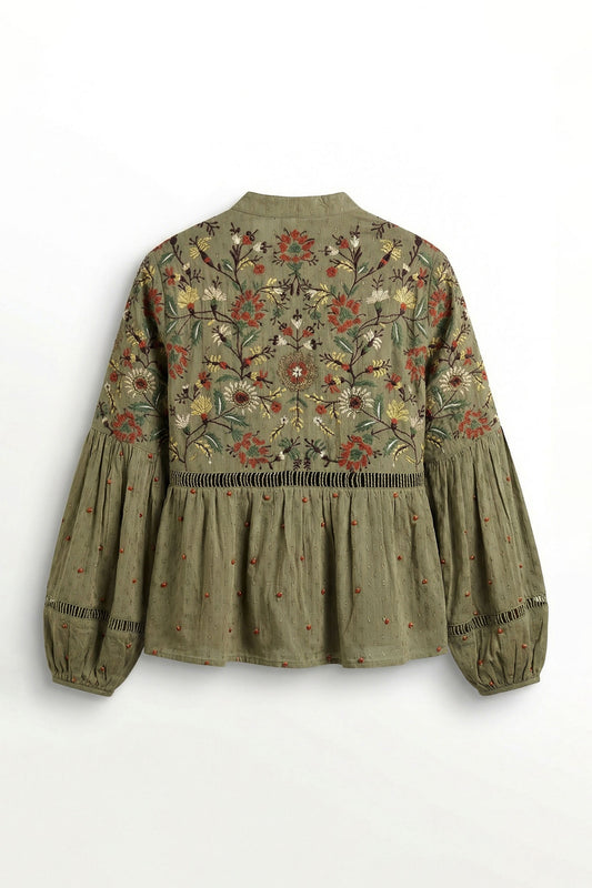 Green embroidered blouse on a white background