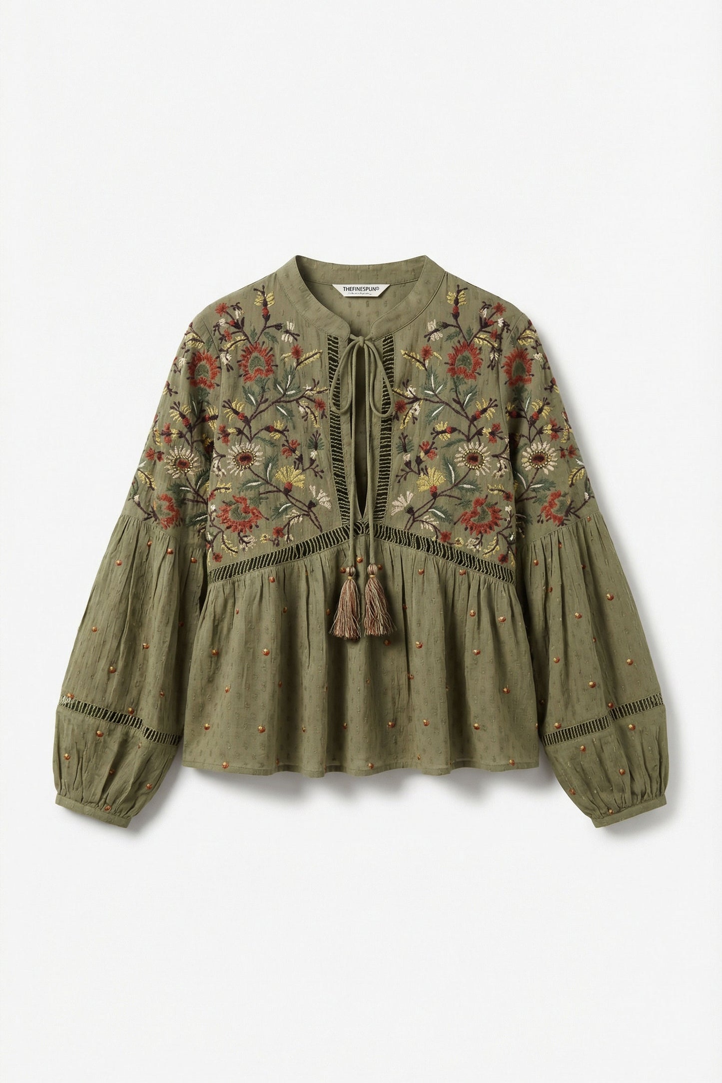 Green embroidered blouse on a white background