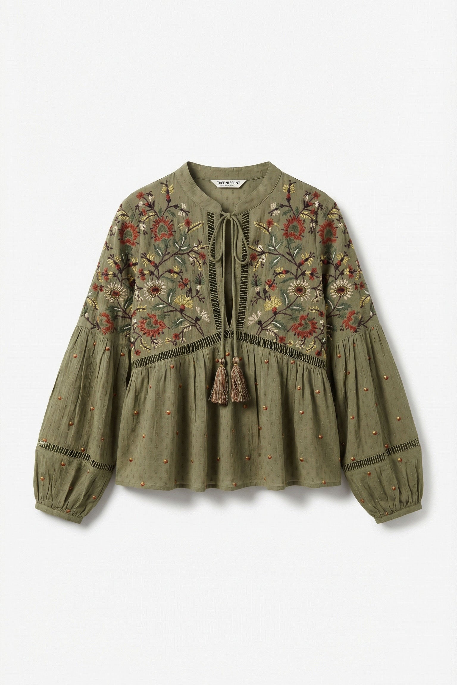 Green embroidered blouse on a white background