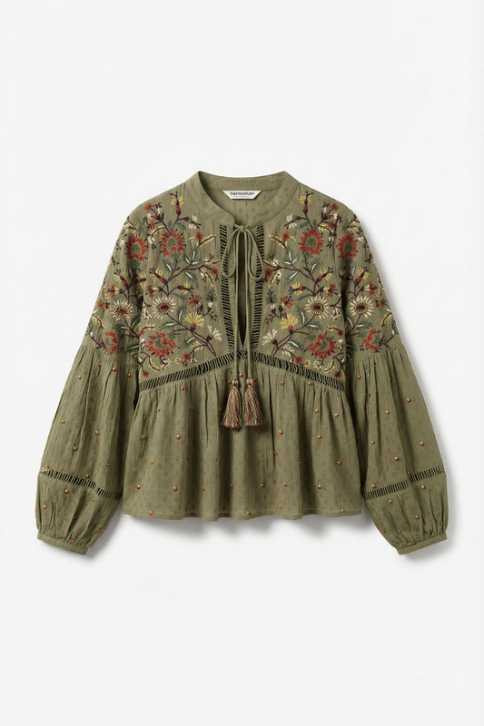 Green embroidered blouse on a white background