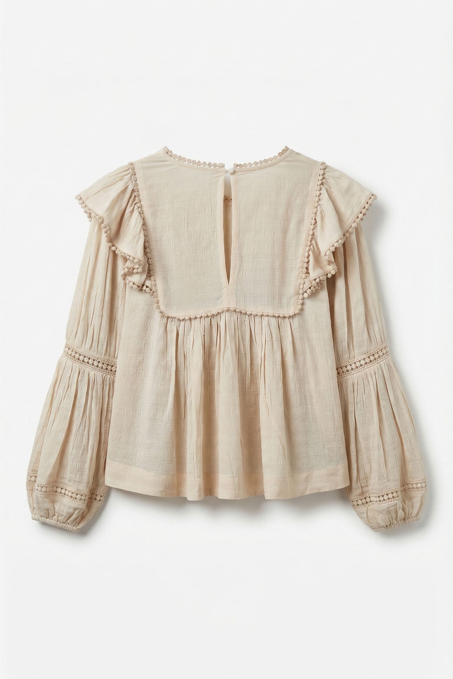 Beige blouse with ruffled details on a white background