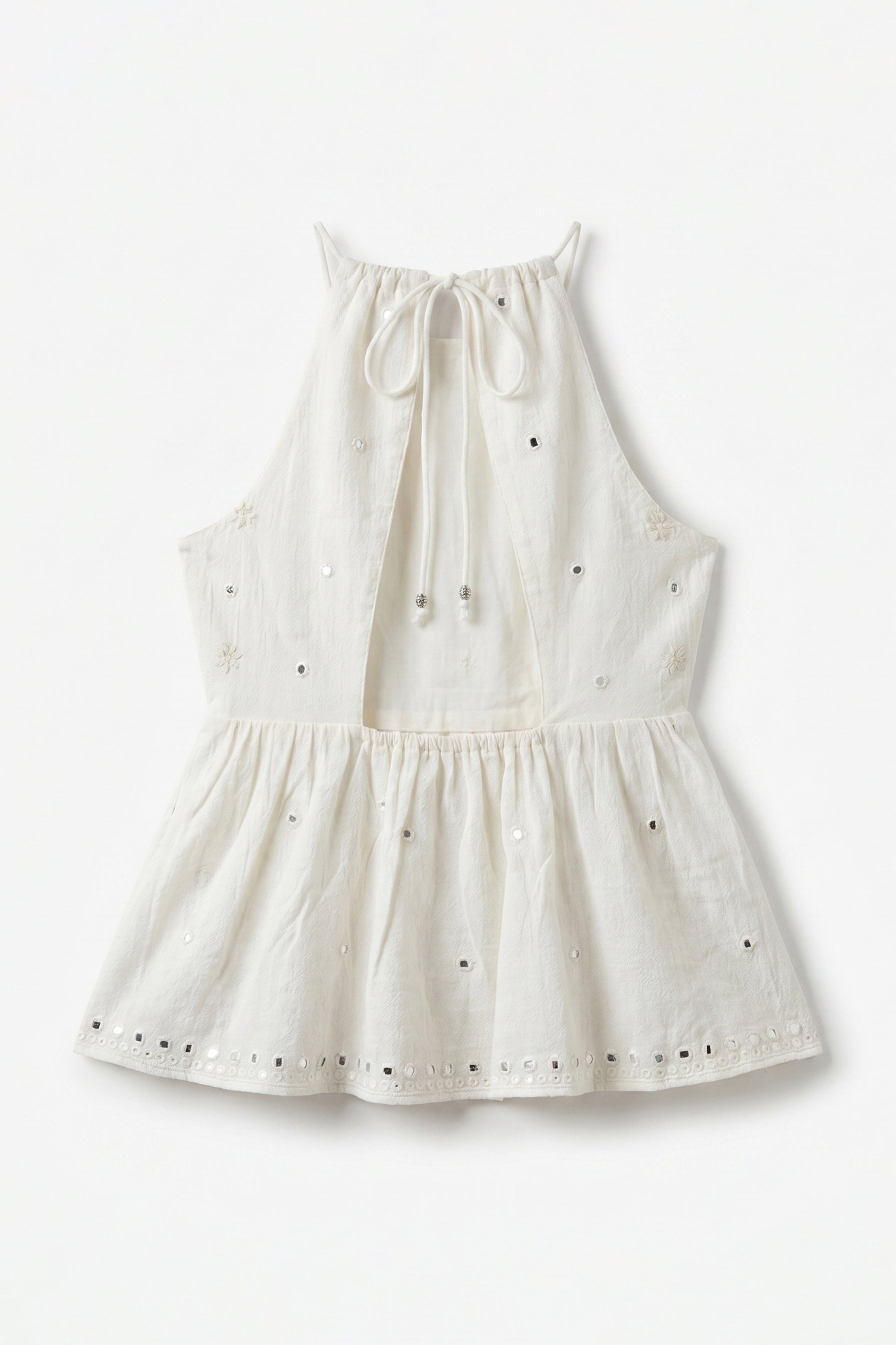 White dress with black polka dots on a white background