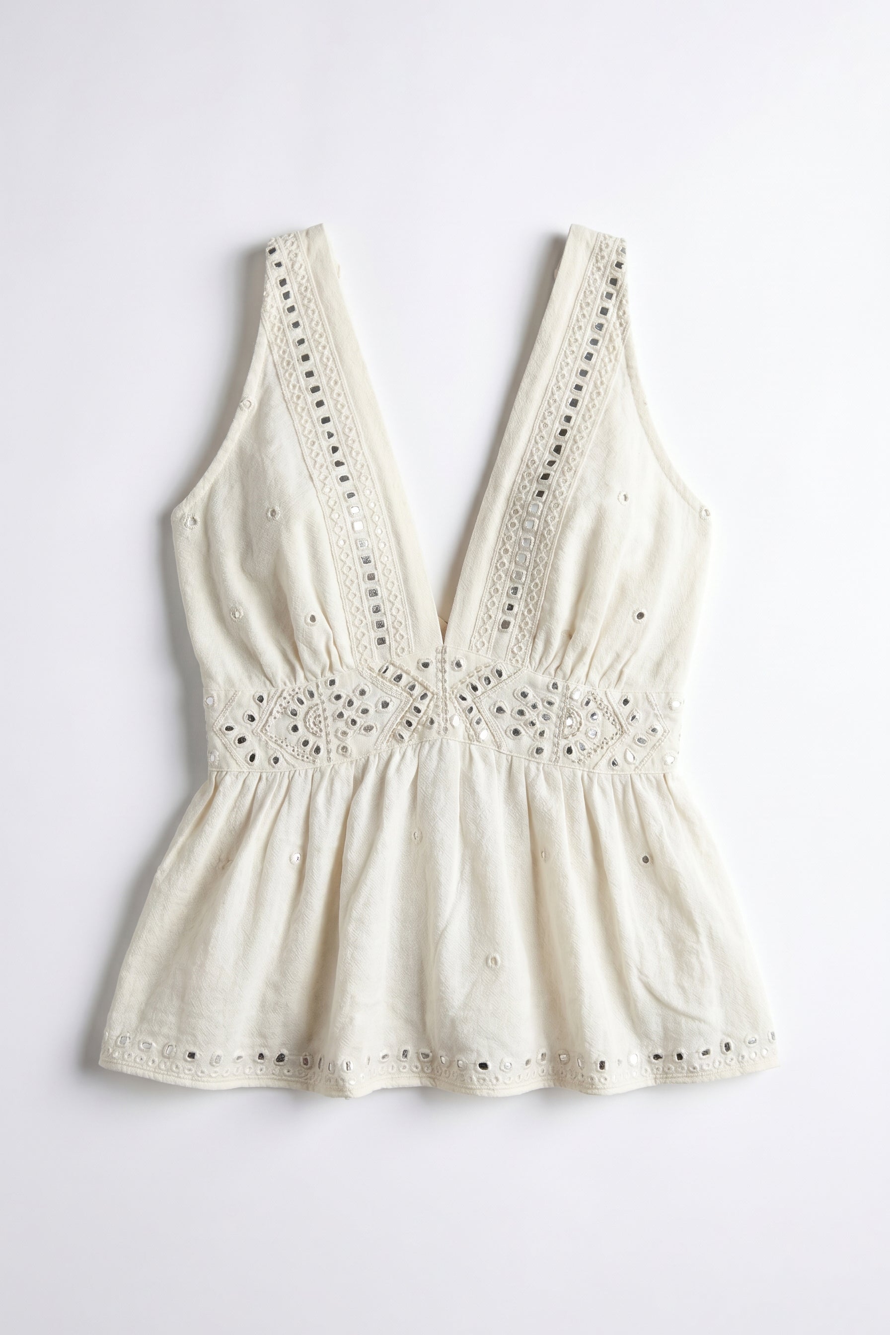 White lace-trimmed top on a light gray background