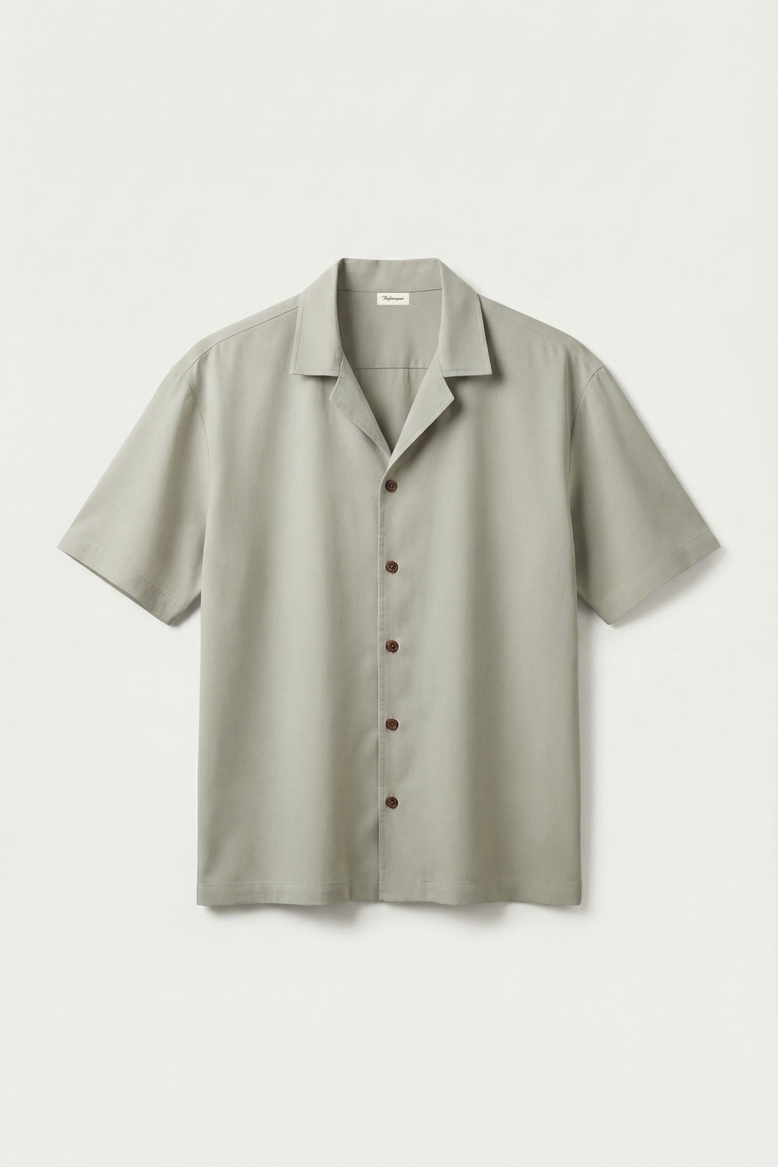 Light gray short-sleeve shirt on a light gray background