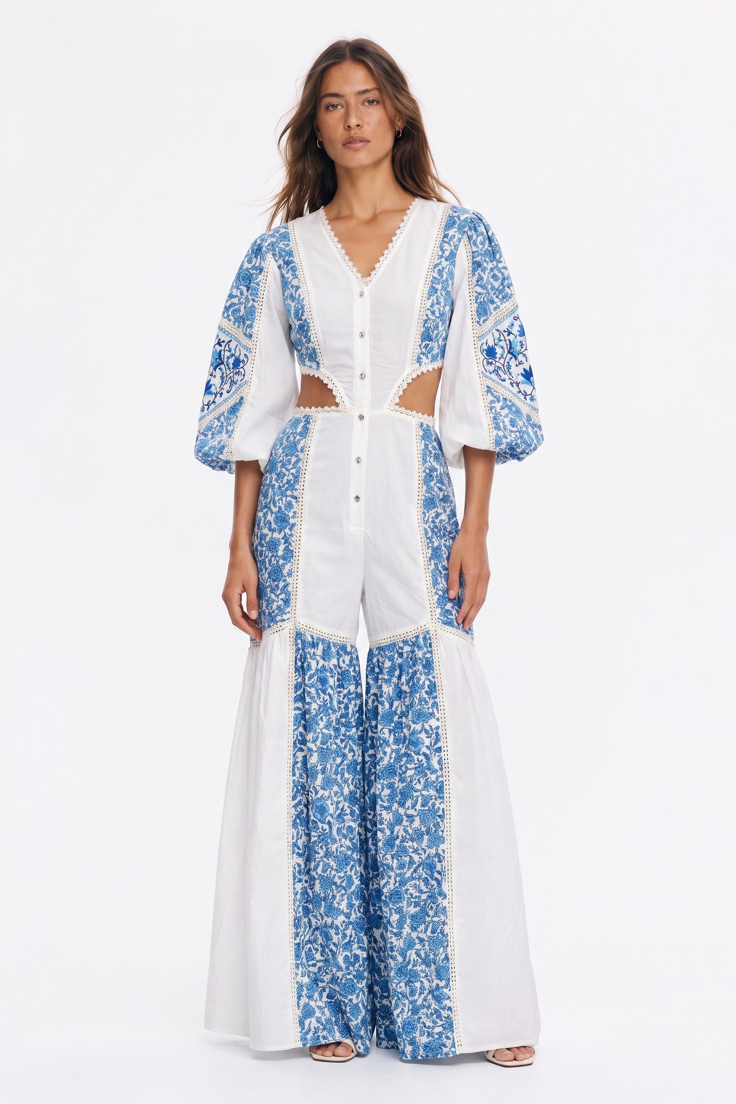 Women's long jumpsuit with embroidery and lace details.