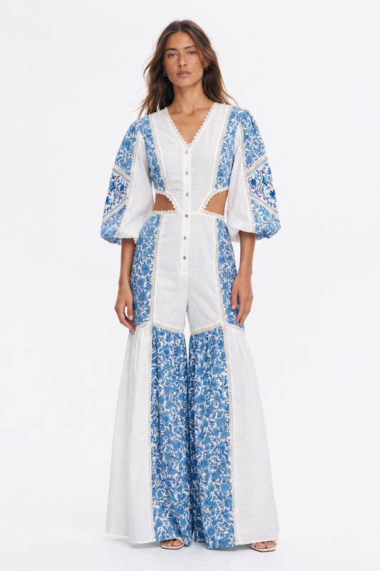 Women's long jumpsuit with embroidery and lace details.