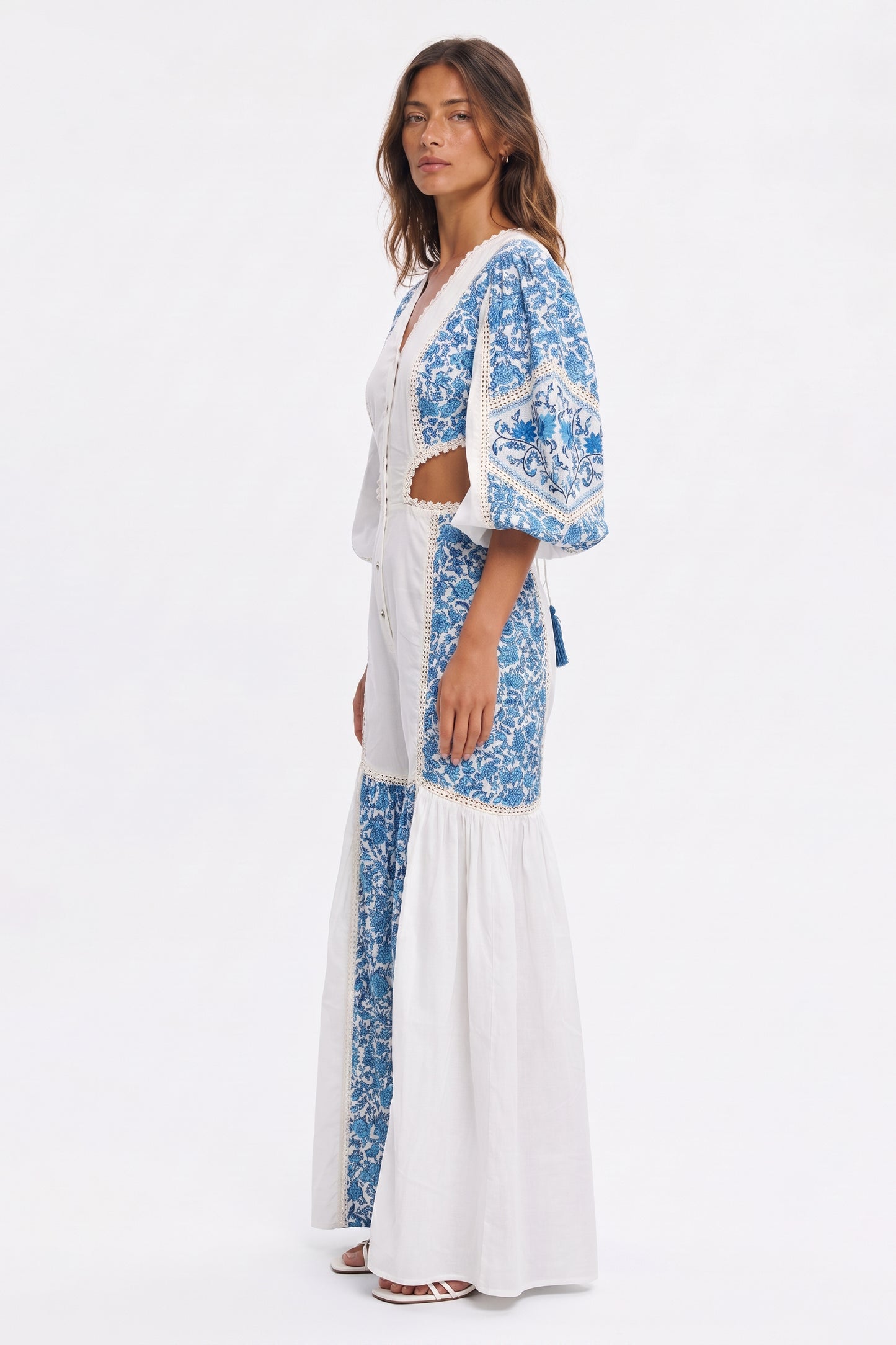 Women's long jumpsuit with embroidery and lace details.