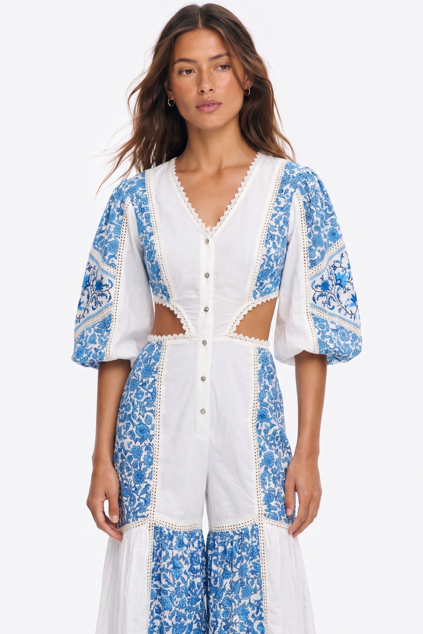 Women's long jumpsuit with embroidery and lace details.
