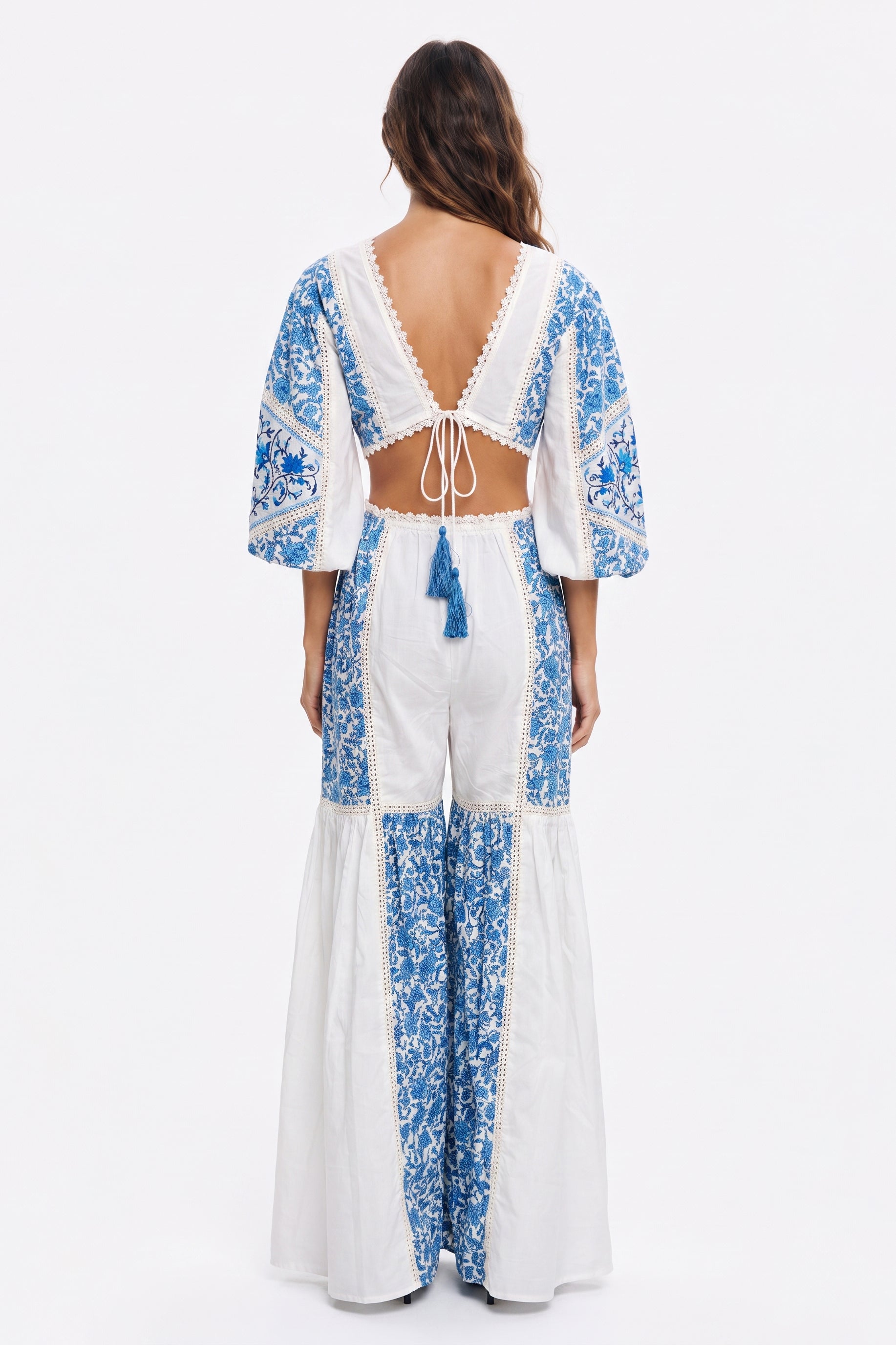Women's long jumpsuit with embroidery and lace details.