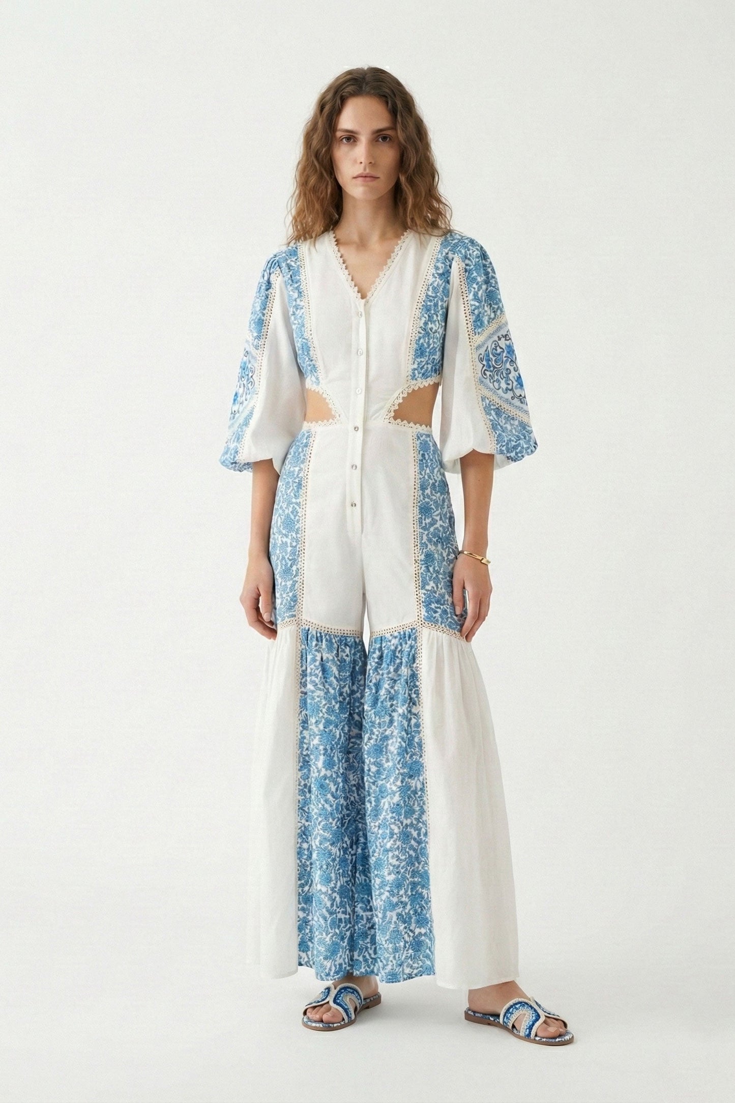 Woman wearing a blue and white floral kimono-style outfit on a white background