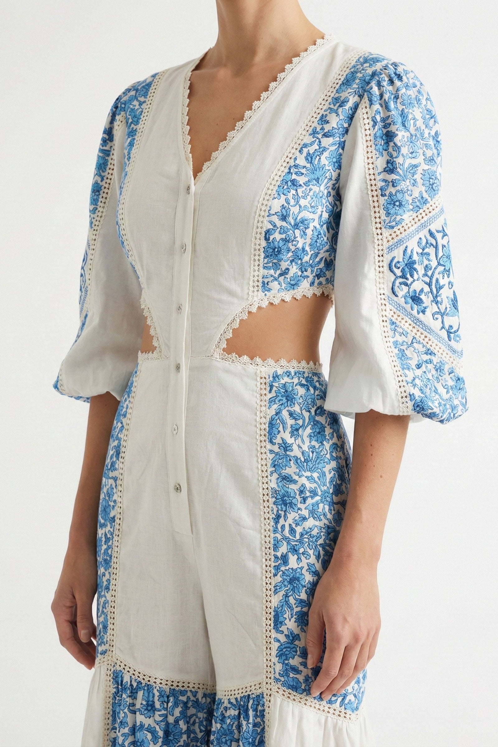 White and blue floral embroidered outfit on a white background