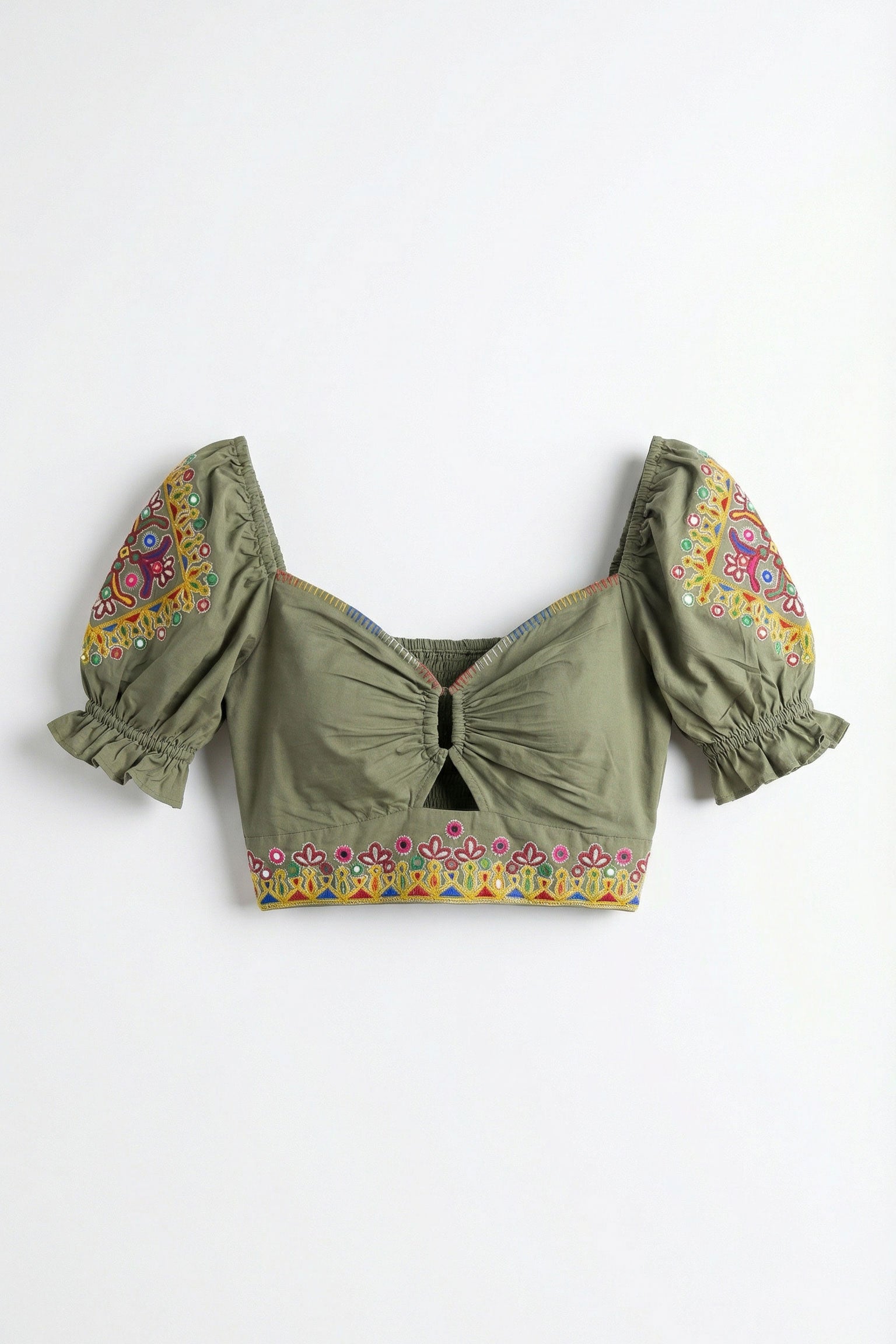 Green crop top with floral embroidery on a white background