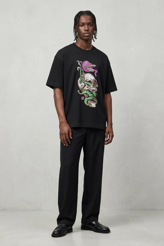 Person wearing a black t-shirt with a colorful graphic design on a plain background