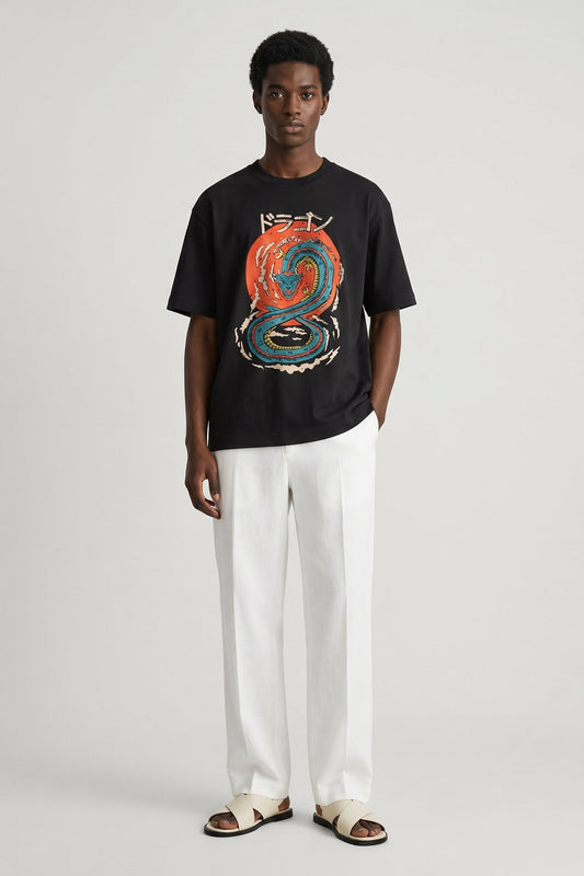 Person wearing a black t-shirt with a colorful graphic design on a plain background