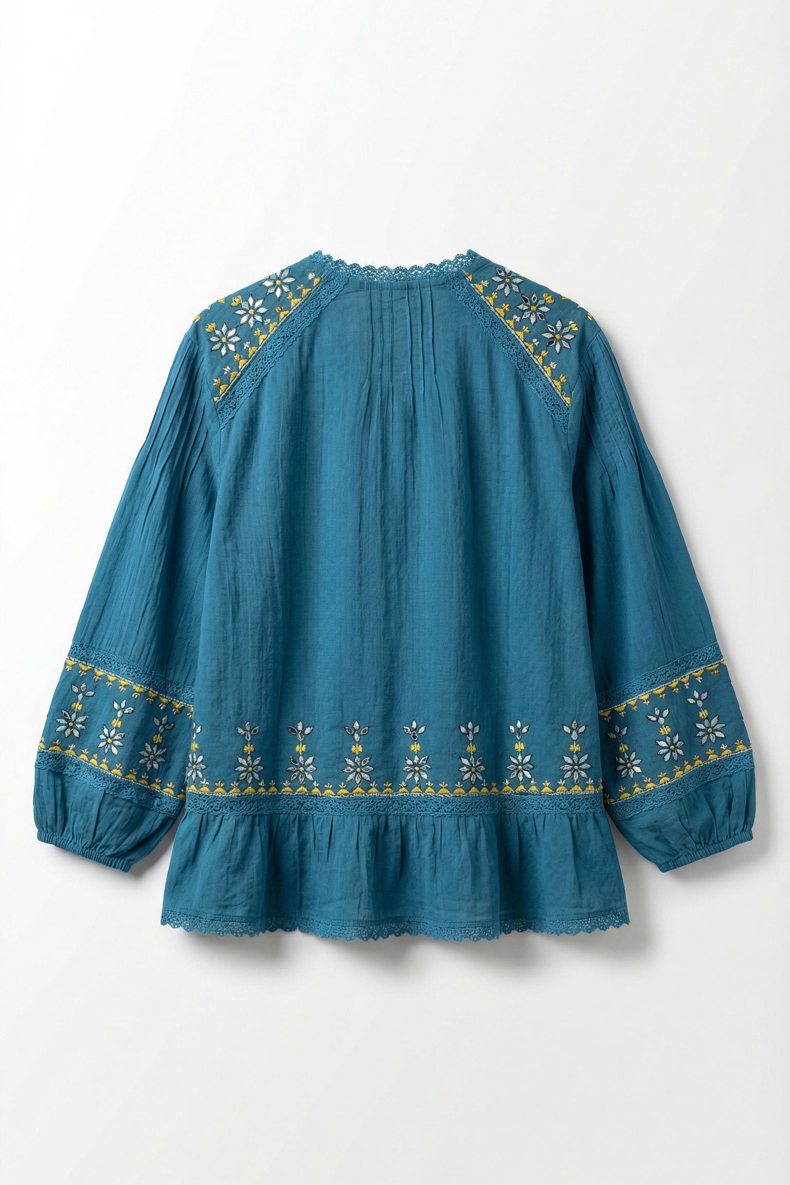 Blue blouse with gold embroidery on a white background