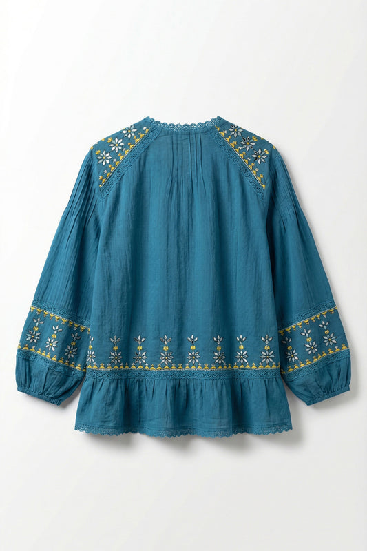 Blue blouse with gold embroidery on a white background