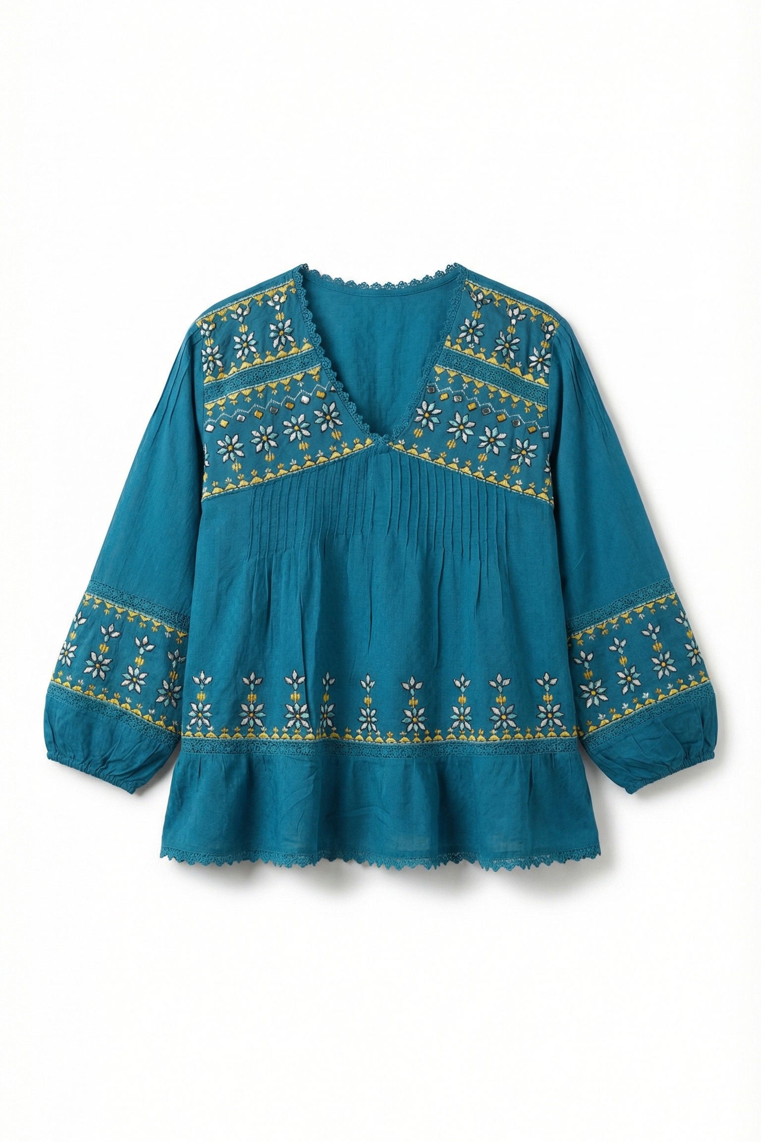 Teal blouse with gold embroidery on a white background