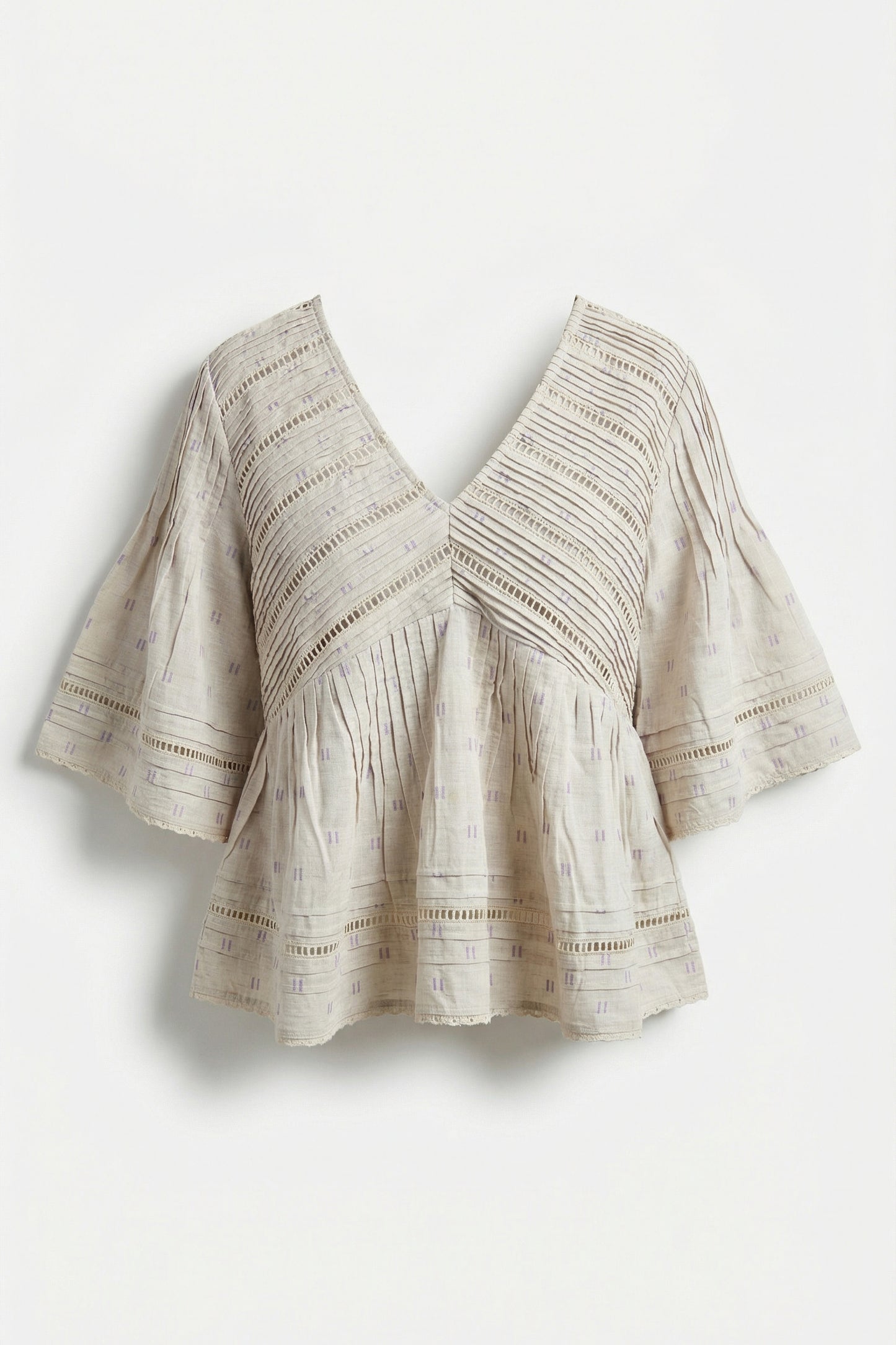 Beige patterned blouse on a light gray background