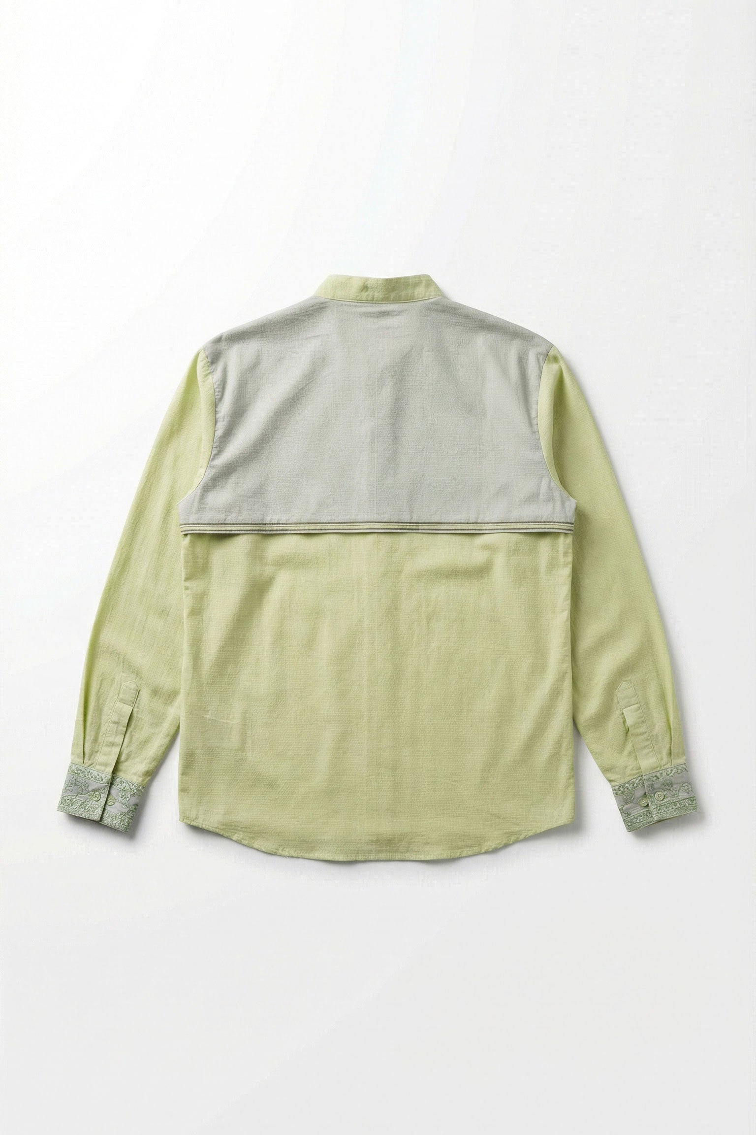 Light green shirt with gray accents on a white background