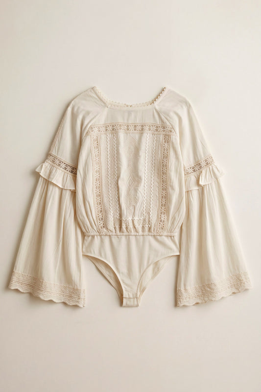 Yasmin white rayon bodysuit featuring tonal daisy embroidery, lace detailing, flared sleeves and an open back with tassel ties