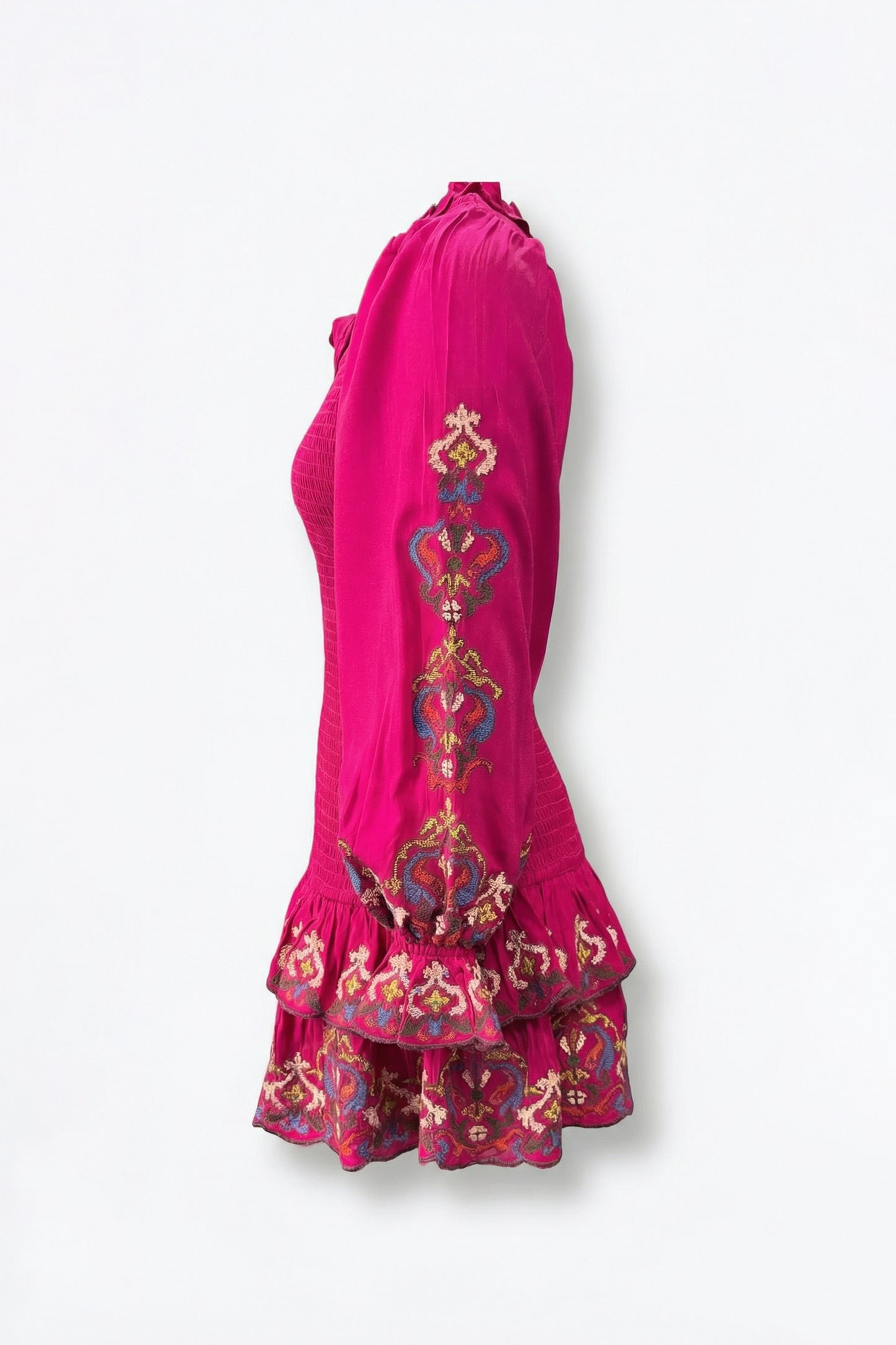 Pink dress with intricate embroidery on a white background