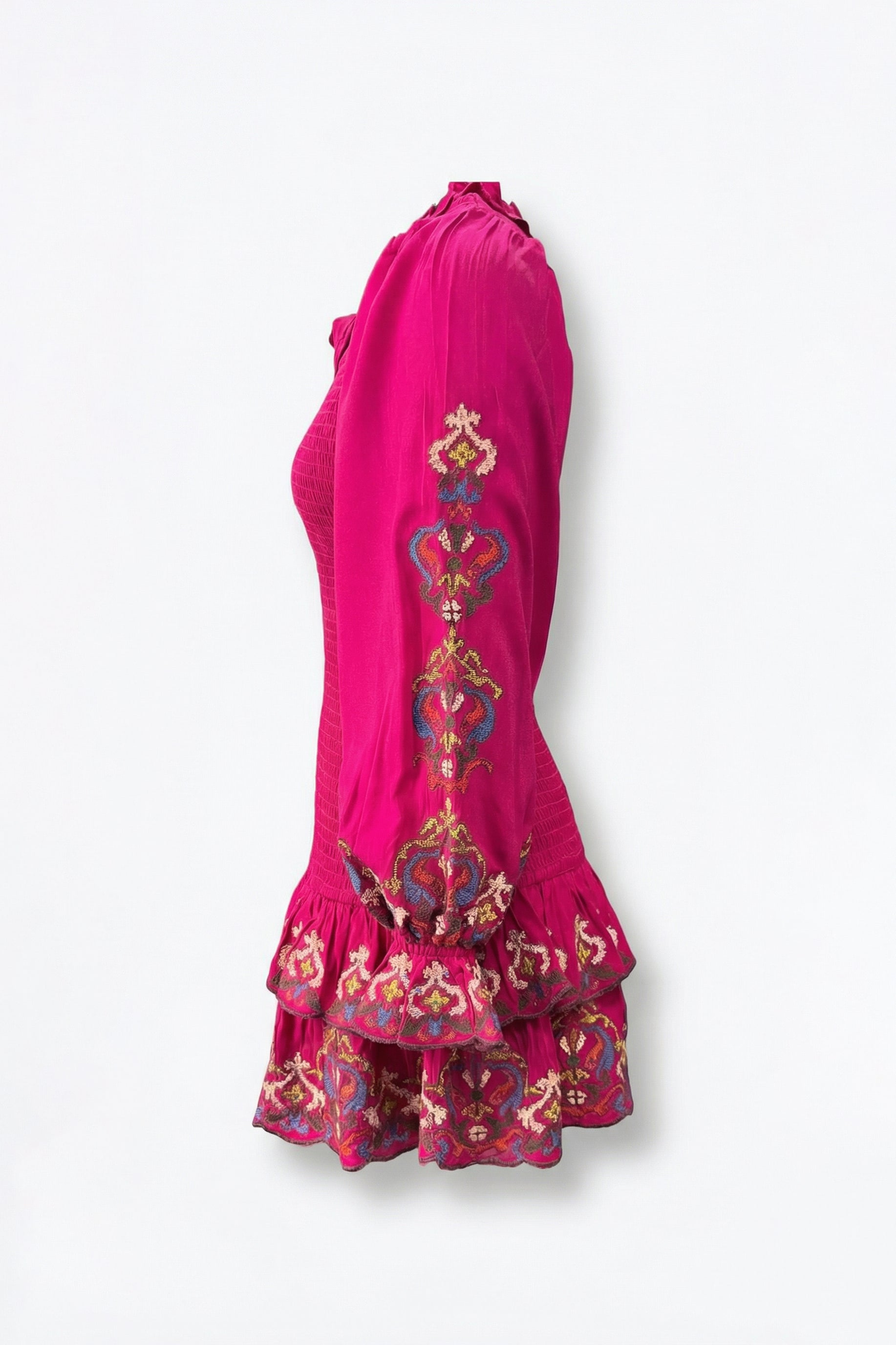 Pink dress with intricate embroidery on a white background